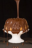 Chocolate glaze being poured over a Madeira Bundt cake