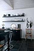 Flagons, carafes, antique soda siphon and goblet - flea market treasures on rusty metal cabinet against brick wall