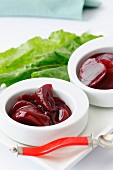 Two Small Bowls of Pickled Beets; Red Spoon