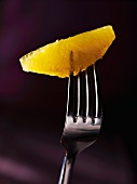 An orange fillet on a fork