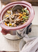 Beef stew being made in a slow cooker