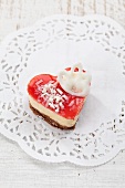 A heart-shaped cake with cream filling and a red jelly topping