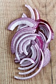 Sliced red onion on a wooden surface