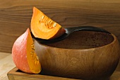 Hokkaido pumpkin wedges with a wooden bowl