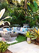 Grey sofa set with striped cushions on terrace