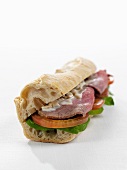 Baguette sandwich with roast beef and tomatoes