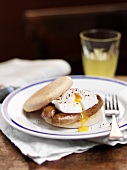 English muffin with sausage and poached egg
