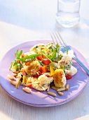 Gnocchi salad with rocket, pine nuts and peppers