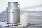 A milk churn and a glass of milk