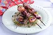 Sausage kebabs with onions and peppers on a bed of rice