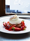 A profiterole with cream and fresh strawberries (choux chantilly)