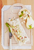 Meringue roulade with caramel cream and pears