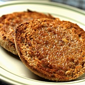 Buttered Whole Wheat Toasted English Muffin on a Plate