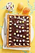 Mazurek (Polish Easter cake) with chocolate, almonds and sugar eggs