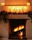 Open fire & Christmas decorations on mantelpiece