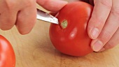 Cutting the stalk and core out of tomatoes