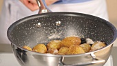Cooked potatoes with a salt crust in a pot