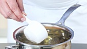 An egg being poached in vinegar water