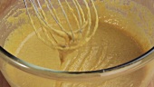 Chickpea batter being mixed with a whisk