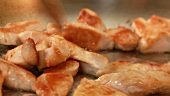 Chicken breast strips being fried