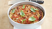 A deep dish pizza with basil leaves (Chicage, USA)