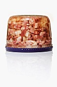 Pork head aspic in a screw top jar