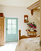 Rustic bedroom with wooden furniture and fresh flowers