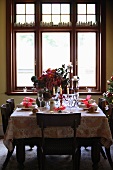 A table laid for Christmas dinner in front of a large window
