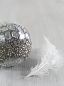 Silver Christmas tree bauble and white feather
