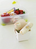 Rice paper rolls in a take-away box