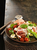 Vegetable salad with ham, tomatoes and basil