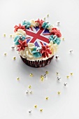A cupcake topped with butter cream and a Union Jack