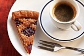 A slice of Linz tart and a cup of espresso