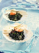 Black rice with prawns served in seashells (Spain)
