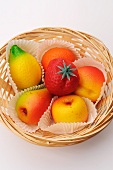 Various marzipan fruits in a basket