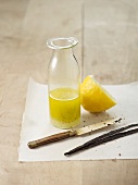 Lemon juice with sugar and fresh vanilla in a glass bottle