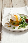 A poached egg on a potato and cabbage cake