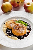 Baked apple slices with plum and elderberry compote