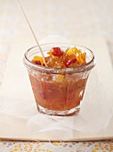 A glass of apricot and strawberry jam