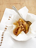 Baked peach wedges with nuts in parchment paper