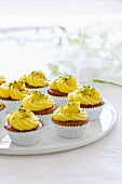 Cupcakes decorated with lemon cream and pistachio nuts
