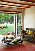 Coffee table on castors in front of open terrace doors in Mediterranean living room