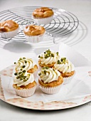 Cupcakes decorated with white frosting and pistachio nuts