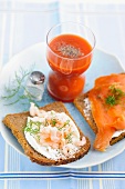 Tomato juice and wholemeal bread topped with prawns and salmon