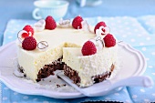 Mango and coconut cake with raspberries, sliced