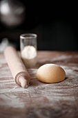 Pasta dough, a rolling pin and flour