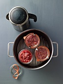 Beef tartare being poached in jars