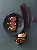 Saddle of venison wrapped in potato with mulled wine and onion chutney and red cabbage and nut strudel