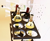 Various bottles of wine in a wine rack on a table laid for Christmas dinner