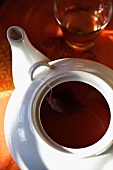 A fruit tea bag in a teapot